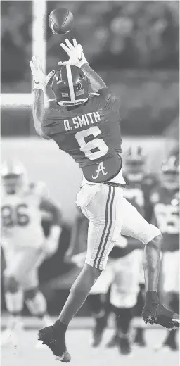  ?? KEVIN C. COX/GETTY (WILLIAMS)
MIKE EHRMANN/GETTY (JONES, SABAN) ?? Alabama quarterbac­k Mac Jones and coach Nick Saban, left, celebrate a blowout victory over Ohio State, a win that was helped in large part by DeVonta Smith, top.