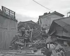  ?? RANGGA FIRMANSYAH/AP ?? Rescue teams and civilians in Cianjur, Indonesia, look for people buried in collapsed brick homes on Monday.