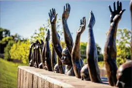  ?? AUDRA MELTON PHOTOS / THE NEW YORK TIMES ?? “Raise Up,” a sculpture by Hank Willis Thomas, on the grounds of the new National Memorial for Peace and Justice in Montgomery, Ala., on April 20. The site is a reckoning with the lynchings of blacks in the United States.