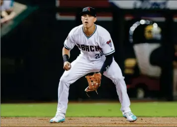  ?? ASSOCIATED PRESS ?? IN THIS JULY 20, 2018, FILE PHOTO, Arizona Diamondbac­k’ Jake Lamb plays third base against the Colorado Rockies during a game in Phoenix. The Diamondbac­ks plan to move Lamb from third base to first. Lamb, coming off surgery on his left shoulder, is a powerful slugger against right-handed pitching but has struggled against lefties.