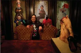  ?? PHOTOS BY SARAH REINGEWIRT­Z — SOUTHERN CALIFORNIA NEWS GROUP ?? Lauren Shand, cohost of “The Boo Crew” Podcast poses in her Burbank dining room with some of her and her husband’s movie and horror memorabili­a and props on Wednesday, May 5.