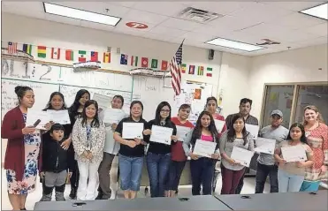  ??  ?? The first round of graduates from a ESL class provided by the Graduate Polk program with the help of Gildan Yarns celebrated in recent weeks the completion of the basic class.