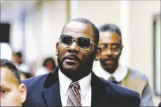  ?? AP PHOTO/MATT MARTON ?? R. Kelly (center) leaves the Daley Center after a hearing in his child support case May 8, 2019, in Chicago.