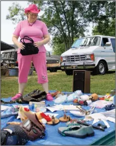  ??  ?? Janet Kendrick looks through various items along U.S. Highway 41 in Ringgold, Ga., during the 2011 Dixie Highway 90-Mile Yard Sale.