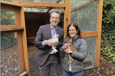  ?? PHOTOS BY TERRY CHEA — AP PHOTO ?? Ron and Allison Abta hold hens in front of their backyard chicken run in Ross. After talking for years about setting up a backyard coop, they finally did so in August.