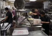  ?? DANIELLE VILLASANA — THE NEW YORK TIMES ?? A pizza is prepared in the kitchen of Star Pizza in Houston on Jan. 23. Star Pizza lost power during a storm in 2021.