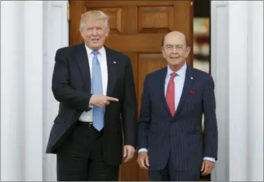  ?? CAROLYN KASTER — THE ASSOCIATED PRESS ?? In this Sunday file photo, President-elect Donald Trump, left, stands with investor Wilbur Ross after meeting at the Trump National Golf Club Bedminster clubhouse in Bedminster, N.J. Trump is poised to offer the position of commerce secretary to the...