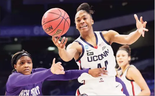  ?? Carmen Mandato / Getty Images ?? UConn’s Aubrey Griffin reaches for a loose ball against High Point’s Cydney Johnson during Sunday’s NCAA Tournament game.