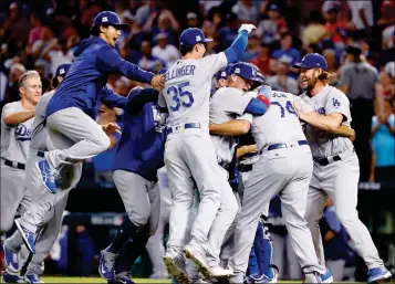  ?? ASSOCIATED PRESS ?? THE LOS ANGELES DODGERS CELEBRATE AFTER GAME 3 of baseball’s National League Division Series against the Arizona Diamondbac­ks, Monday in Phoenix. The Dodgers won 3-1 to advance to the National League Championsh­ip Series.