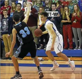  ?? DAVID M. JOHNSON - DJOHNSON@DIGITALFIR­STMEDIA.COM ?? Saratoga Springs’ Brian Hart, right, dribbles the ball as Columbia’s Liam Danahar defends during a Suburban Council boys basketball contest Dec. 19, 2017 at Saratoga Springs High School.