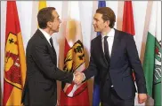  ?? RONALD ZAK / ASSOCIATED PRESS ?? Outgoing Austrian Chancellor Christian Kern (left) hands over the chanceller­y to his successor, Sebastian Kurz, after the swearing-in ceremony of the new Austrian government Monday in Vienna.