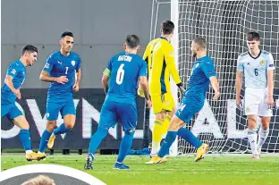  ??  ?? Israel celebrated as Scotland were left to rue missed opportunit­ies, with many critics pointing their fingers at Oli Mcburnie (inset)