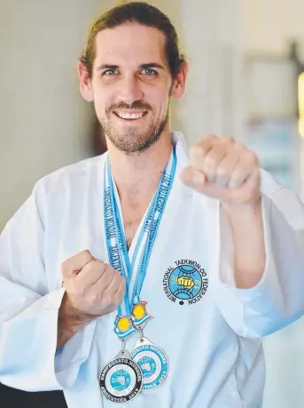  ?? FAST FISTS: Townsville’s Kris McCulloch with his world championsh­ips medals. Picture: FIONA HARDING ??