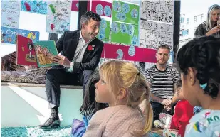  ?? PHOTO: RNZ ?? Story time . . . Act New Zealand leader and Minister for Regulation and Associate Education David Seymour reads Oi Frog! to children at an Early Childhood Education centre in Wellington before speaking to reporters.