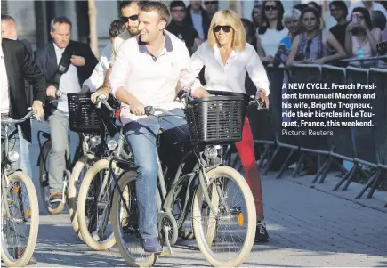  ?? Picture: Reuters ?? A NEW CYCLE. French President Emmanuel Macron and his wife, Brigitte Trogneux, ride their bicycles in Le Touquet, France, this weekend.