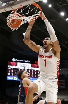  ?? Justin Casterline/Getty Images ?? Obi Toppin dunks for two of his 28 points Saturday for No. 5 Dayton in its 80-70 win against Duquesne in Dayton, Ohio.