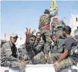  ?? SEDAT SUNA, EUROPEAN PRESSPHOTO AGENCY ?? Kurdish fighters flash victory signs in June 2015 as they battle to liberate the Syrian town of Raqqa, an Islamic State stronghold.