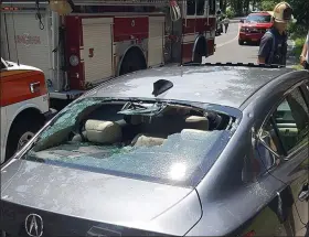  ?? KPD PHOTO ?? JULY 30: This car is among four damaged when rocks being used as ballast fall from a CSX freight train as it crosses the trestle above Abeel Street in Kingston’s Rondout district. Two people are injured.