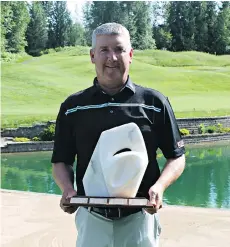  ??  ?? Doug Morgan displays the winners trophy after finishing first at the B.C. Senior’s Championsh­ips at Salmon Arm Golf Club on Tuesday.