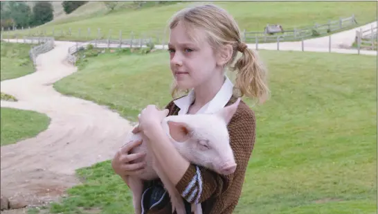  ?? ?? Dakota Fanning and Wilbur the pig (voiced by Dominic Scott Kay) in “Charlotte’s Web”