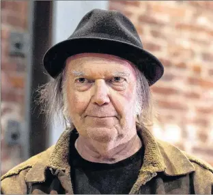  ?? CP PHOTO ?? Canadian musician Neil Young leaves a news conference in Vancouver, B.C., in November 2015. Young recorded his 1976 acoustic album “Hitchhiker” in a single day, but until now fans could only dream of getting their hands on it.