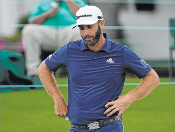  ?? Gregory Bull The Associated Press ?? Dustin Johnson became the 11th defending Masters champion to miss the 36-hole cut when he bogeyed three of his final four holes Friday. He missed the cut by two shots.