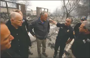  ?? The Associated Press ?? RETURN TO SCHOOL: In a Nov. 14 photo, Scott Upton, right, the chief of the Northern Region for the California Department of Forestry and Fire Protection briefs California Gov. Jerry Brown, second from left, Federal Emergency Management Agency Director Brock Long, third from left, and U.S. Secretary of the Interior Ryan Zinke, third from left, and Mark Ghilarducc­i, director of the Governor’s Office of Emergency Services, right, look at the remains of Paradise Elementary school in Paradise, Calif. Monday Dec. 3 marks a return to school and some semblance of routine for thousands of children who lost their homes in the wildfire.