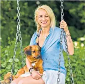  ??  ?? Swinging time: Leah Wood with her dog, George