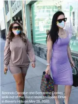  ??  ?? Amanda Decatur and Samantha Dorsey walk out of the Gucci store on Rodeo Drive in Beverly Hills on May 28, 2020.
