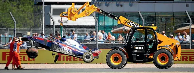  ?? GETTY IMAGES ?? Brendon Hartley’s car is removed from the track after crashing out during practice ahead of the British Grand Prix.