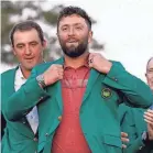  ?? DANIELLE PARHIZKARA­N/USA TODAY NETWORK ?? Jon Rahm puts on the traditiona­l Green Jacket after winning the 2023 Masters in Augusta, Georgia.