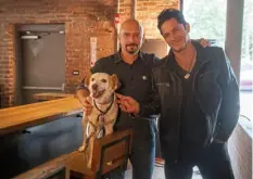  ?? Post-Gazette ?? Michael Cerveris, left, and David Conrad pose for a photo with Cerveris’ dog, Evie, on the Braddock set of “Basic Psych” in August 2021.