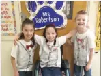  ?? SUBMITTED ?? Second-grader Colleen Herron is surrounded by her best friends, Deandra Shehane and Spencer Seel. The students, along with others at Central Primary School and in the Arkadelphi­a community, are rallying together to support Colleen on her cancer journey...