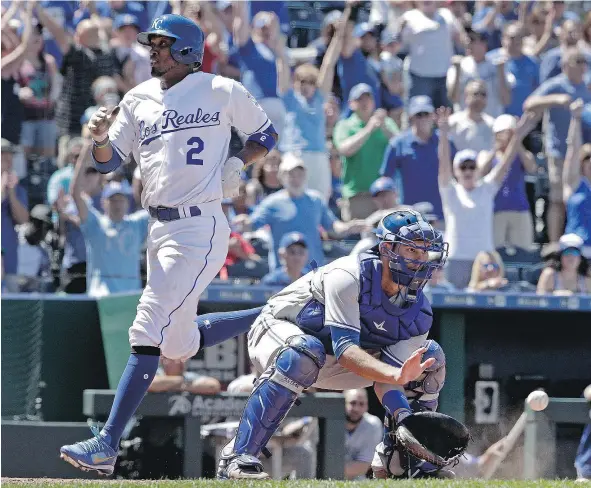  ?? — THE ASSOCIATED PRESS ?? Kansas City’s Alcides Escobar beats the tag by Blue Jays catcher Luke Maile to score on a triple by Alex Gordon during the seventh inning of Saturday’s game in Kansas City. That proved to be the winning run as the Royals beat the Jays 3-2.