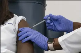  ?? MARK LENNIHAN — THE ASSOCIATED PRESS FILE ?? Sandra Lindsay, left, a nurse at Long Island Jewish Medical Center, is inoculated with the Pfizer-BioNTech COVID-19 vaccine by Dr. Michelle Chester in the Queens borough of New York on Dec. 14.