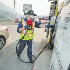  ??  ?? “As long as we have gas, we’ll get people the gas,” says Miles St. Amand, who’s hard at work at Sun Valley Gas on Highway 97.