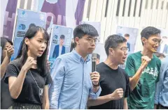  ??  ?? UNITED AS ONE: Pro-democracy activist Au Nok-hin, second right, marks the fifth anniversar­y of the Umbrella Movement in Hong Kong last year.