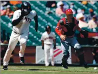  ??  ?? Giants pitcher Johnny Cueto runs to first base after dropping down a bunt as Cincinnati Reds catcher Tyler Stephenson goes to pick up the ball during the fifth inning.
Online: