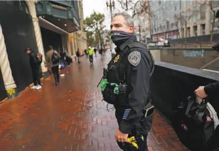  ?? Scott Strazzante / The Chronicle ?? Officer Eric Hofstein, shown on Market Street, has a moral compass that “points true north all the time,” a partner said.