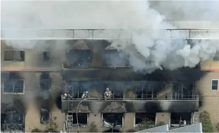  ?? AP PHOTO ?? Firefighte­rs battle a fire at Kyoto Animation in Kyoto, Japan on Thursday. Kyoto police said an unidentifi­ed man set fire to the building, killing 33 people and injuring 36 others.