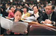  ?? XU JINGXING / CHINA DAILY ?? A deputy reads a document at the fourth plenary meeting of the first session of the 13th National People’s Congress in Beijing on Tuesday.