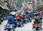  ??  ?? DEADWOOD: Motorcycli­sts ride through downtown Deadwood, South Dakota during the 80th Annual Sturgis Motorcycle Rally. —AFP