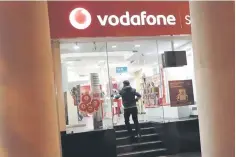  ??  ?? A customer enters a Vodafone store in New Delhi, India. Companies like Vodafone Group, Cairn Energy and Deutsche Telekom have initiated arbitratio­n proceeding­s against India seeking to protect their investment­s against retrospect­ive tax claims and...