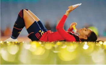  ?? ?? Spain's Salma Paralluelo lies on the ground with her medal at the end of the Women's World Cup soccer final between Spain and England at Stadium Australia in Sydney, Australia, Sunday, Aug. 20, 2023. Spain won 1-0. (AP Photo/Abbie Parr)