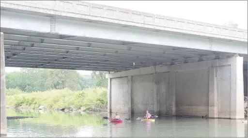  ?? Keith Bryant/The Weekly Vista ?? Brooke Murphy, left, and Mary Curtis head under U.S. Highway 71, just North of Riordan Road. Curtis said this bridge is always an interestin­g part of the float because several birds nest in it and start flying around overhead when they see people...