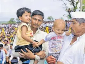  ?? HT PHOTO ?? Slain jawan Sandip Jadhav's father (in white) and two children attend his funeral at Kelgaon village in Aurangabad on Saturday. Jadhav, who was among the two soldiers killed in a crossborde­r ambush, was cremated on his son’s first birthday.