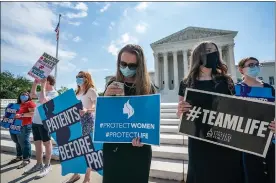  ?? Associated Press ?? ■ Anti-abortion activists wait outside the Supreme Court for a decision Monday in Washington on the Louisiana case, Russo v. June Medical Services LLC.