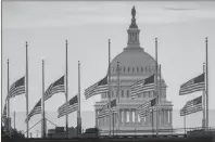  ?? AP PHOTO ?? Flags flying a half-staff in honour of Sen. John McCain, R-Ariz., frame the U.S. Capital at daybreak in Washington Sunday.