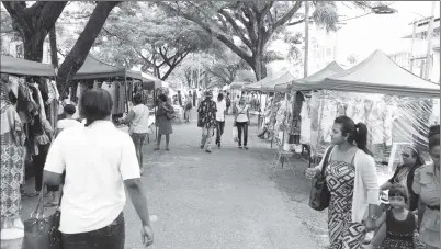  ?? (Photo by Keno George) ?? Pre-emancipati­on street sale on Main Street on Saturday where African wear and food were among the items on offer.