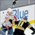  ?? MATT STONE / BOSTON HERALD ?? Boston’s Trent Frederic takes his gloves off to try to fight Washington’s Alex Ovechkin during the third period at TD Garden on Wednesday.